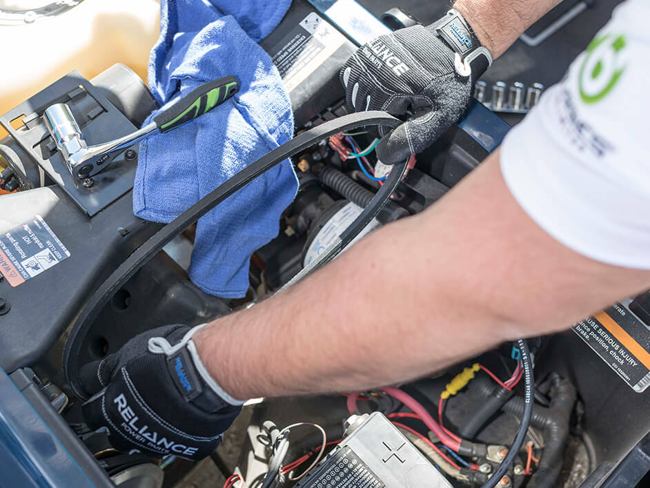 mechanic replacing golf cart's starter belt