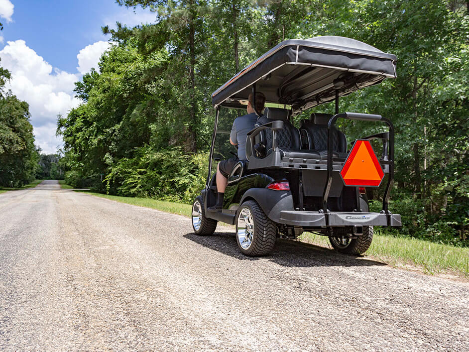 golf cart on street with slow moving vehicle safety triangle