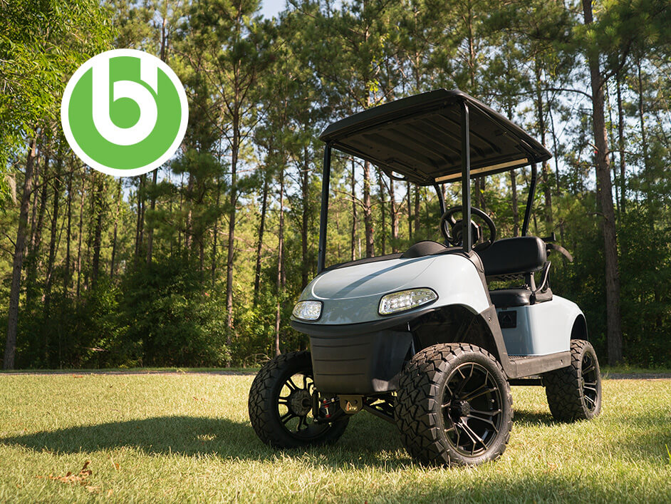 golf cart on grass with buggies logo on top left